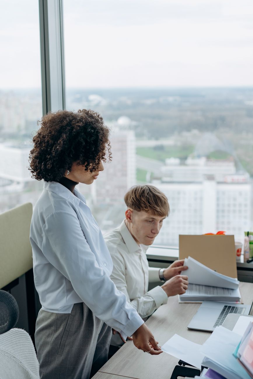 Real estate professional team reviewing property paperwork